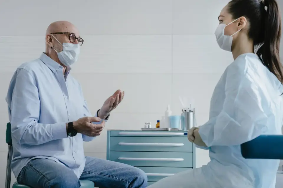 A veterinarian discussing a senior dog&#x27;s evening symptoms with the owner